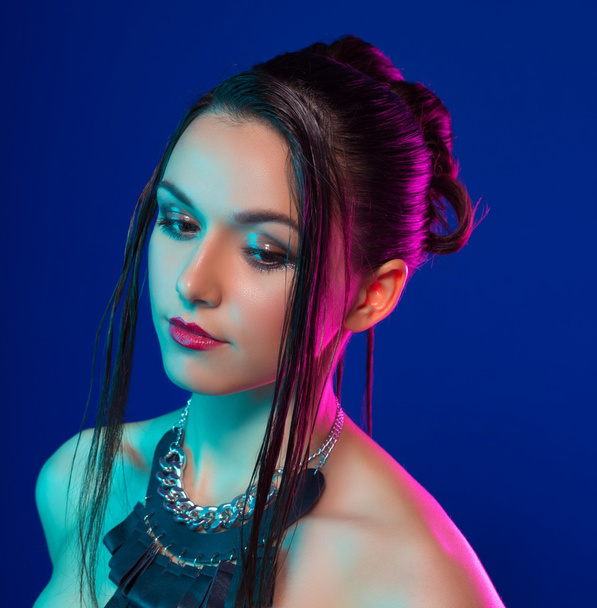 beautiful girl with a hairdress. studio shot on blue background - Zdjęcie, obraz