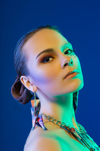 woman with colorful make-up on blue - Foto, Imagen