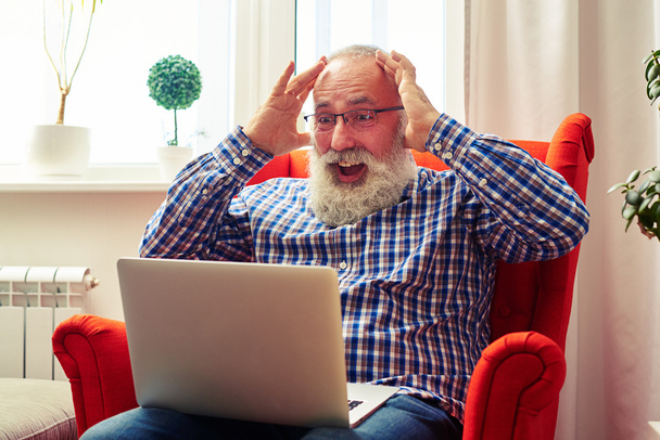 surprised senior man with laptop - Photo, Image