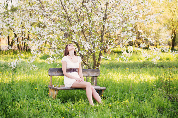 Beautiful young girl in spring garden - Fotografie, Obrázek