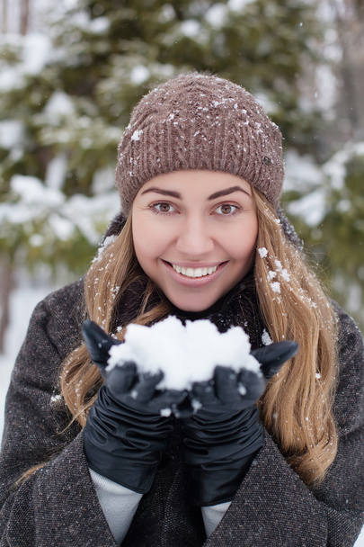 girl outdoor portrait. Winter woman blowing snow in a park, closeup - Foto, Imagen
