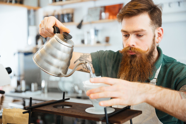Barista pouring water on coffee ground with filter  - Foto, imagen