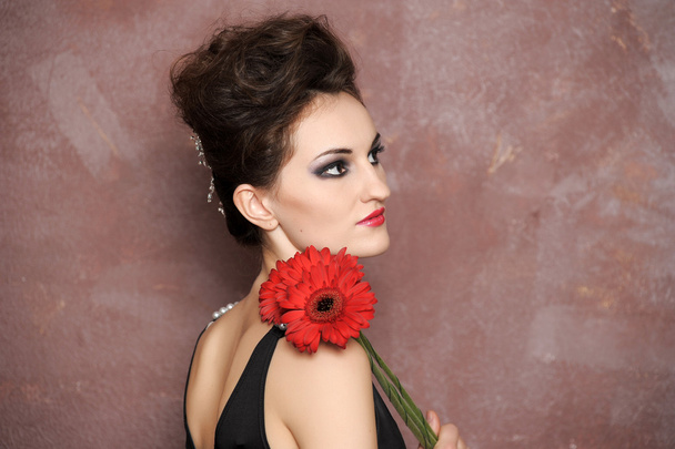 Attractive woman with red flowers - Zdjęcie, obraz
