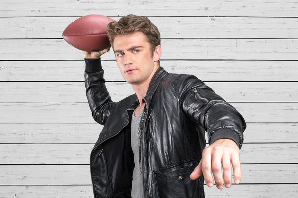 man football player portrait holding american football - 写真・画像