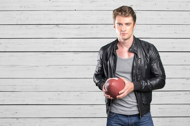 man football player portrait holding american football - Foto, Imagen