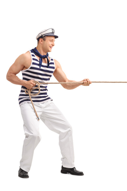 Young male sailor pulling a rope  - Foto, Imagen