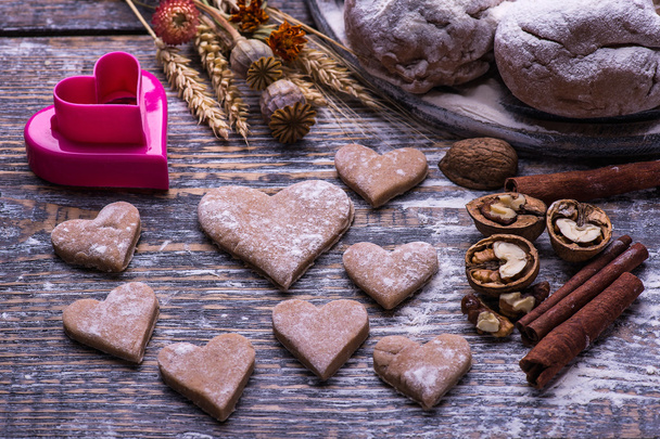 Baking ingredients for making biscuits, cookies in the shape of heart on wooden board. St.Valentine"s Day. - Photo, image