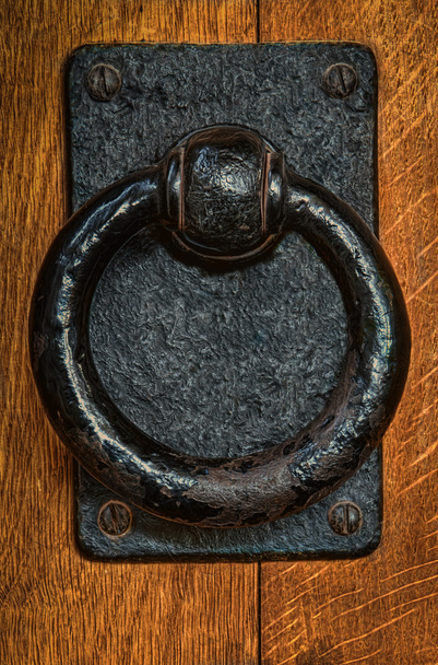 Staré černé kovové kruhové klepadlo na dubové dveře - Fotografie, Obrázek