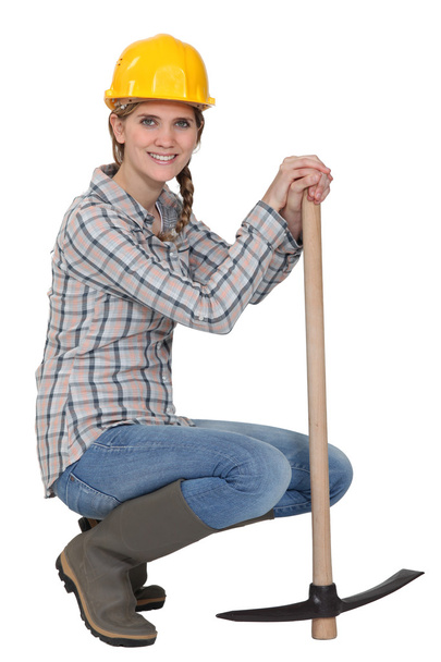 A woman with a pickaxe. - Фото, изображение