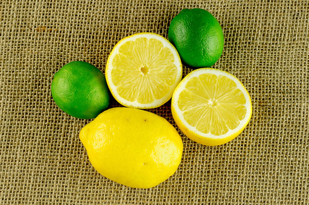 Aerial view of lemons and limes upon hessian textured cloth - Photo, Image