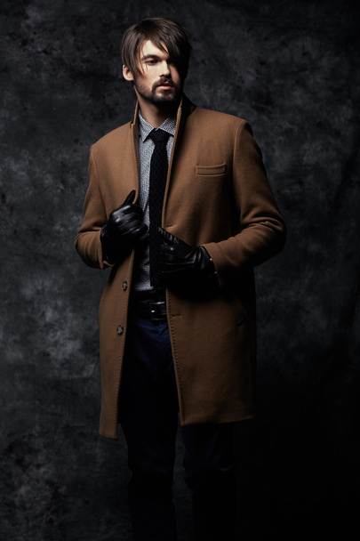 Young handsome man in a coat - studio male portrait - Foto, immagini