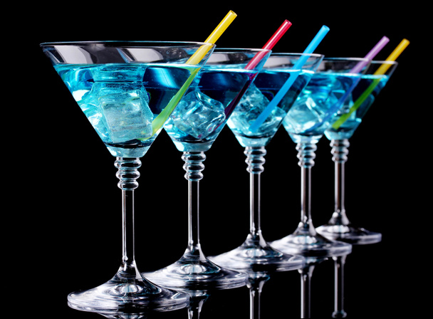 Blue cocktail in martini glasses isolated on black - Fotoğraf, Görsel