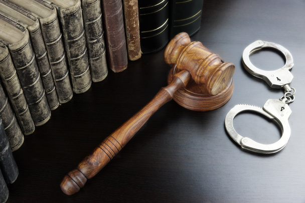 Judges Gavel, Handcuffs And Old Book On The Black Table - 写真・画像