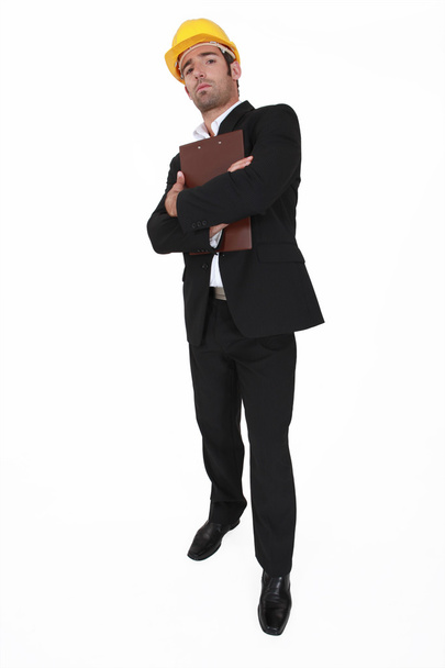 Businessman in a hardhat with a clipboard - Фото, изображение