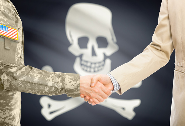 USA military man in uniform and civil man in suit shaking hands with flag on background - Jolly Roger - symbol of piracy - Fotografie, Obrázek