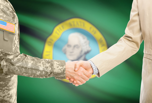 USA military man in uniform and civil man in suit shaking hands with USA state flag on background - Washington - Fotografie, Obrázek