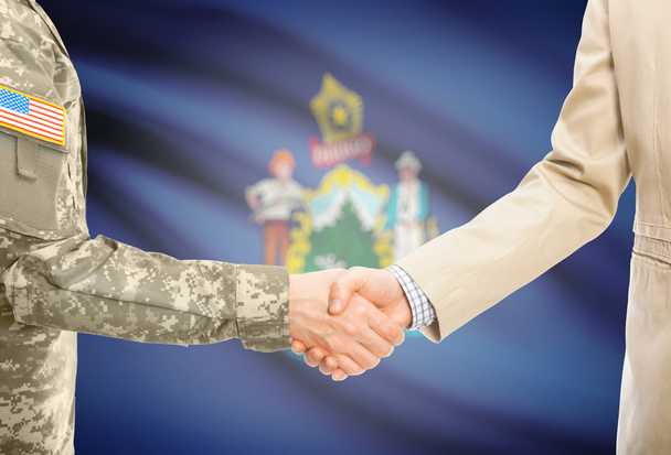 USA military man in uniform and civil man in suit shaking hands with USA state flag on background - Maine - Fotografie, Obrázek