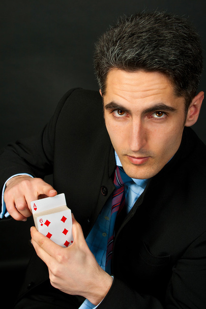 Young lucky gambler with cards - Foto, afbeelding