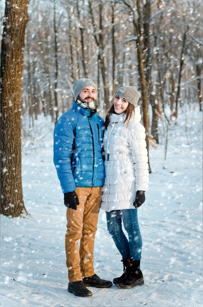 happy couple in love in winter forest - Фото, изображение