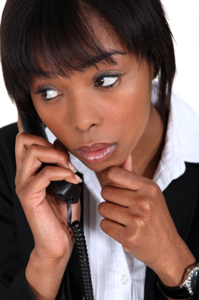 Concerned businesswoman taking phone call - Foto, afbeelding