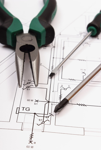 Metal pliers and screwdriver on electrical construction drawing of house - Photo, Image