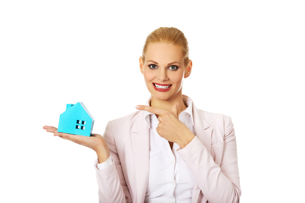 Smile business woman holding a paper house - 写真・画像