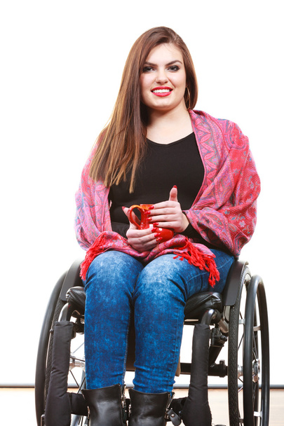Woman invalid girl on wheelchair holds tea mug - Fotoğraf, Görsel