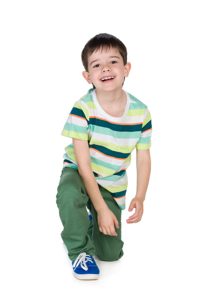 Little boy in a striped shirt sits - Foto, Imagen