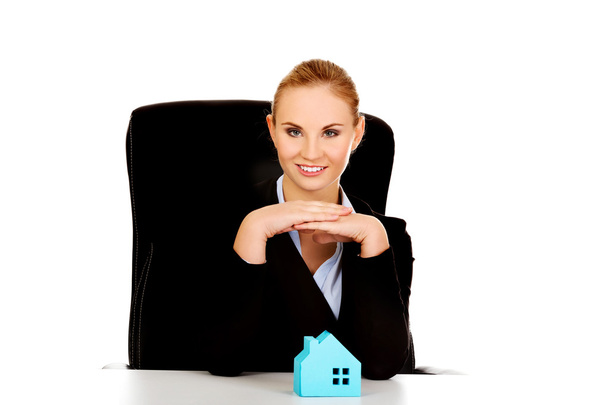 Business woman with blue paper house on the desk - Photo, image