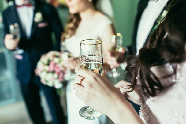 bridesmaid holding glass with champagne on wedding - Foto, Imagem