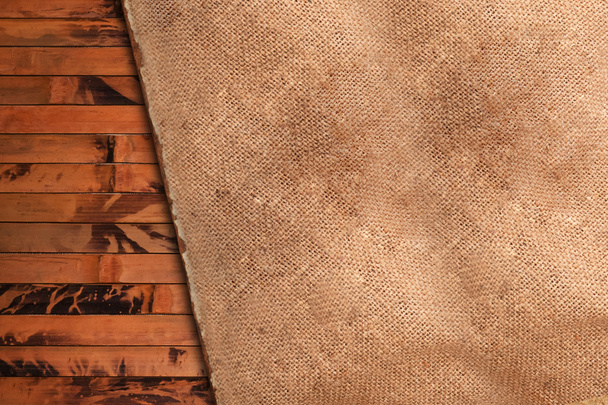 Crumpled old cloth on a wooden background - Фото, зображення