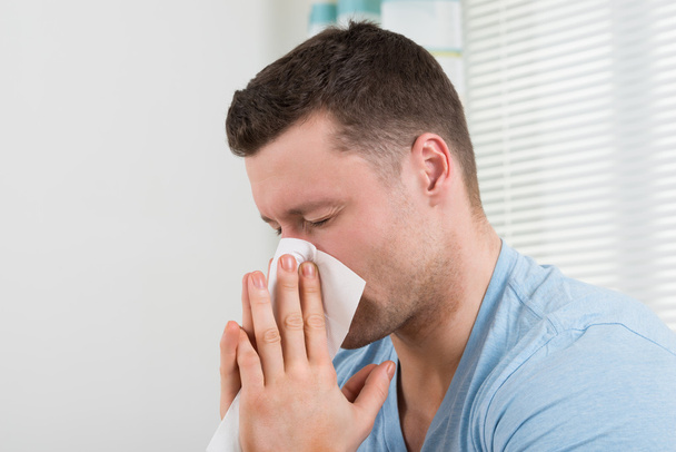 Man With Cold Blowing His Nose - Foto, immagini