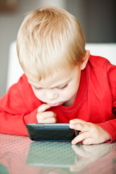 Little boy with media player - Photo, image