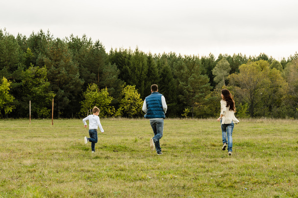 Family walking outdoors in summer - Foto, imagen