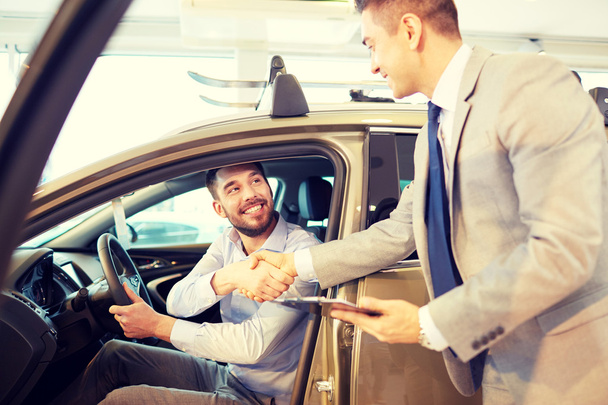 happy man with car dealer in auto show or salon - Zdjęcie, obraz