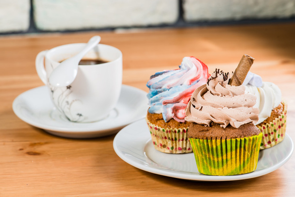 cakes on a saucer with a coffee on a wooden background (shallow  - Foto, immagini