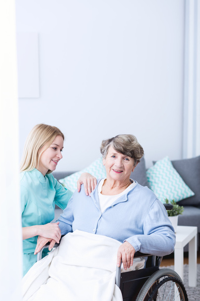 Caregiver supporting senior lady - Фото, зображення