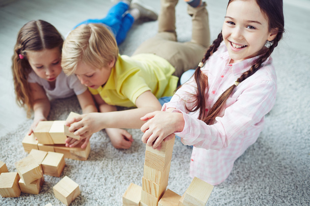 Children playing with wooden blocks - Fotó, kép