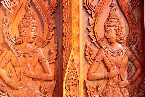 Native Thai style carving, painting on church door in the temple - Photo, image