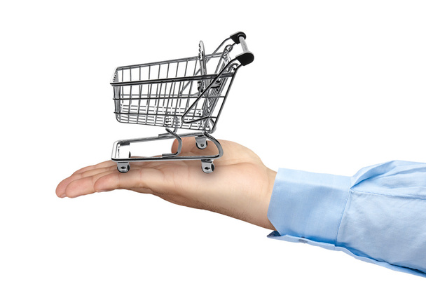 Big hand holding empty shopping cart - Фото, изображение
