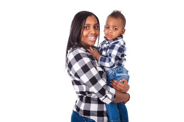 African American mother holding  her little son isolated on whit - Foto, afbeelding