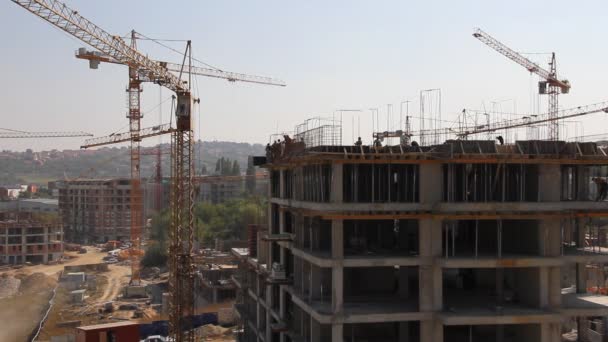 Working cranes near unfinished houses - Footage, Video