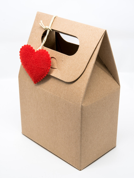 Paper bag with red heart over wrapping paper on white background - Photo, Image