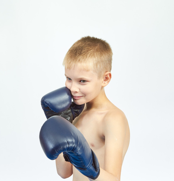 On a light background athlete with boxing gloves on his hands - Foto, Imagen