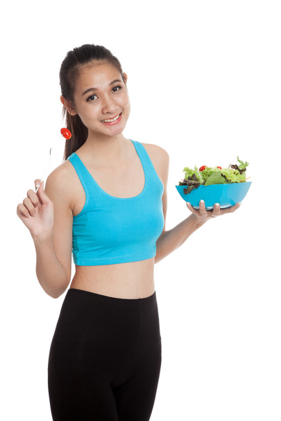 Азиатская здоровая девочка с удовольствием ест салат
 - Фото, изображение