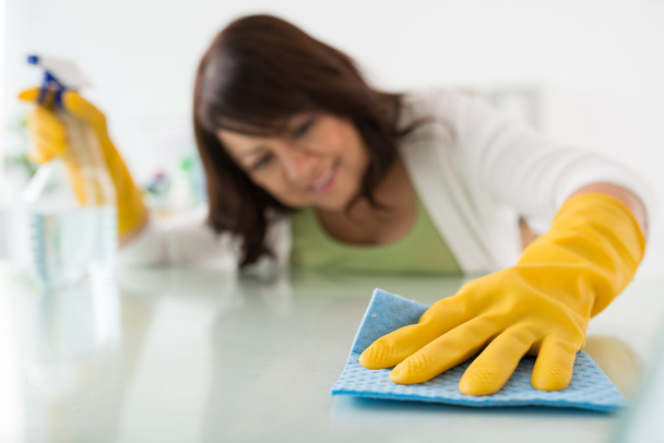 Housekeeper cleaning surface - Fotoğraf, Görsel