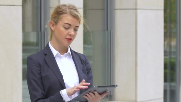 elegant business woman with tablet computer near office building. close up - Кадри, відео