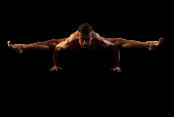 Practice yoga and gymnastics on a black background - Photo, Image