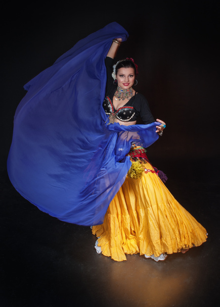 Beautiful exotic belly tribal dancer woman with blue shawl  - Photo, Image