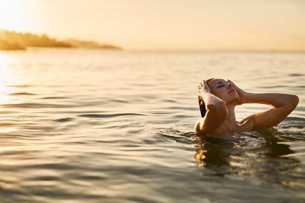 Body Care. Woman Enjoying Sea, Sunset. Healthy Lifestyle. Summer - Fotó, kép